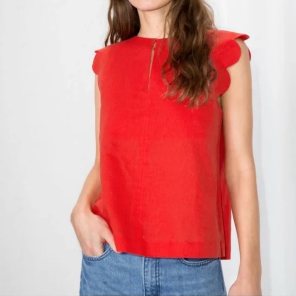 Red sleeveless top with scalloped armholes